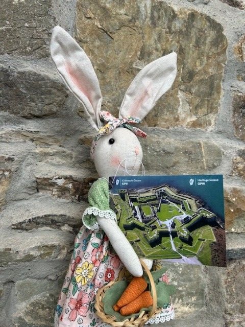 A bunny holds a postcard